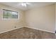 Bedroom featuring neutral walls, plush carpeting, and natural light from one window at 1513 Dupree Rd, Woodstock, GA 30189