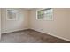 Bedroom featuring neutral walls, plush carpeting, and natural light from two windows at 1513 Dupree Rd, Woodstock, GA 30189