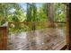 Wooden deck with a wooden railing overlooking a green backyard at 1513 Dupree Rd, Woodstock, GA 30189
