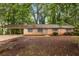 Charming single-story brick home featuring a covered carport and a cozy, inviting curb appeal at 1513 Dupree Rd, Woodstock, GA 30189