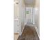 Hallway featuring neutral walls, carpet and several doorways at 1513 Dupree Rd, Woodstock, GA 30189