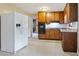 Kitchen with wooden cabinets, black appliances, and a double-door refrigerator for ample storage and cooking convenience at 1513 Dupree Rd, Woodstock, GA 30189