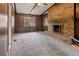 Cozy living room featuring a brick fireplace and wood paneling, creating a warm and inviting atmosphere at 1513 Dupree Rd, Woodstock, GA 30189