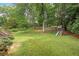 Spacious backyard with lush greenery and a playset, perfect for Gathering activities at 1693 Alderbrook Ne Rd, Atlanta, GA 30345