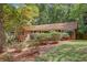 A quaint brick home with manicured bushes and a natural setting at 1693 Alderbrook Ne Rd, Atlanta, GA 30345