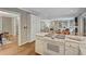 Open kitchen features white cabinets and flows into a living room with built in shelving at 1693 Alderbrook Ne Rd, Atlanta, GA 30345