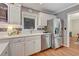 Bright kitchen features white cabinets, stainless steel appliances, and hardwood floors at 1693 Alderbrook Ne Rd, Atlanta, GA 30345