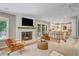 Spacious living room with fireplace flowing into a bright, white kitchen at 1693 Alderbrook Ne Rd, Atlanta, GA 30345