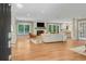 Open-concept living room with hardwood floors, fireplace, and access to the kitchen at 1693 Alderbrook Ne Rd, Atlanta, GA 30345
