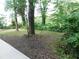 Lush backyard with mature trees and a grassy area, perfect for outdoor activities at 5952 Medlock Ave, Austell, GA 30106