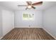 This bedroom has new floors, a ceiling fan, and large closet and window at 5952 Medlock Ave, Austell, GA 30106