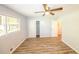 Bright bedroom with modern ceiling fan, wood floors, closet, and a window letting in natural light at 5952 Medlock Ave, Austell, GA 30106