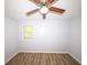 Bedroom featuring neutral paint, wood-look floors, a ceiling fan and a window at 5952 Medlock Ave, Austell, GA 30106