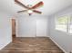 Bedroom features a ceiling fan, a closet, and a window that provides natural light at 5952 Medlock Ave, Austell, GA 30106