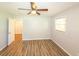 Bedroom featuring neutral paint, wood-look floors, a window, and a doorway at 5952 Medlock Ave, Austell, GA 30106