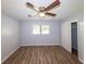 Bedroom featuring neutral paint, wood-look floors, a ceiling fan and a window at 5952 Medlock Ave, Austell, GA 30106