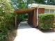 Side view of a home with a wooden carport and neatly trimmed hedges at 5952 Medlock Ave, Austell, GA 30106