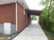 Brick home side view featuring a covered carport area and side access door at 5952 Medlock Ave, Austell, GA 30106