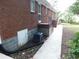 Brick exterior shows the side of the home with a sidewalk, air conditioner, and access to the basement at 5952 Medlock Ave, Austell, GA 30106