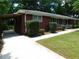 A brick home featuring a covered parking area on a lush green lot at 5952 Medlock Ave, Austell, GA 30106