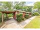 Brick home with a covered parking area and well-manicured landscaping at 5952 Medlock Ave, Austell, GA 30106