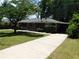 Exterior view of a brick home with a carport and well-maintained lawn at 5952 Medlock Ave, Austell, GA 30106