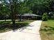 Charming single-story home with a well-maintained front yard, driveway, and a cozy porch at 5952 Medlock Ave, Austell, GA 30106