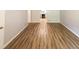 Hallway with wood-look floors leading to a kitchen at 5952 Medlock Ave, Austell, GA 30106