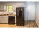 Kitchen with a stainless steel refrigerator, stone countertop, and stainless steel sink at 5952 Medlock Ave, Austell, GA 30106