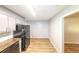 Kitchen with wood floors, stainless steel appliances, and grey cabinets at 5952 Medlock Ave, Austell, GA 30106
