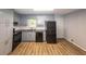 Kitchen with stainless steel appliances, stone countertops, and grey cabinets at 5952 Medlock Ave, Austell, GA 30106