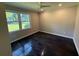 Sunlit bedroom with hardwood floors, two windows, and a ceiling fan at 2545 Glenrock Dr, Decatur, GA 30032