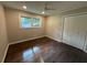 Neutral bedroom with hardwood flooring, a ceiling fan, and a double door closet at 2545 Glenrock Dr, Decatur, GA 30032