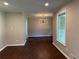 Bright dining room featuring hardwood floors, fresh paint, and a stylish chandelier at 2545 Glenrock Dr, Decatur, GA 30032