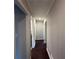 Hallway featuring fresh paint, trim, dark wood floors and modern lighting at 2545 Glenrock Dr, Decatur, GA 30032