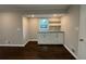 Kitchenette featuring custom cabinets, shelves, and granite countertops, plus dark wood floors at 2545 Glenrock Dr, Decatur, GA 30032