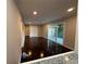 Open living room featuring fresh paint, dark wood floors, ceiling fan, and sliding door to the exterior at 2545 Glenrock Dr, Decatur, GA 30032