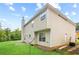 Backyard with a well-kept lawn and the home's exterior showcasing a patio and chimney at 273 Baywood Xing, Hiram, GA 30141