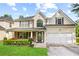 Charming two-story home featuring a well-manicured lawn, covered porch, and a two-car garage at 273 Baywood Xing, Hiram, GA 30141