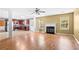 Open-concept living area showcasing a modern fireplace, hardwood floors, and seamlessly connected kitchen at 273 Baywood Xing, Hiram, GA 30141