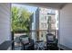 Relaxing balcony with comfortable seating and a view of the surrounding trees and neighboring buildings at 371 Grant Cir # 1813, Atlanta, GA 30315