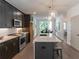 Spacious kitchen with stainless steel appliances, an island with bar stools, and updated countertops at 371 Grant Cir # 1813, Atlanta, GA 30315