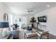 Comfortable living room with two chairs, a sofa, a ceiling fan, and a large flat-screen television at 371 Grant Cir # 1813, Atlanta, GA 30315