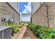 Outdoor space with lush green shrubbery and a gate leading to a back alley for a peaceful outdoor escape at 767 Farmstead Rd, Suwanee, GA 30024