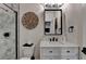This modern bathroom includes marble tile, a glass shower, and black hardware and fixtures at 767 Farmstead Rd, Suwanee, GA 30024