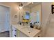 Bright bathroom with double sinks, modern lighting, and stylish decor at 767 Farmstead Rd, Suwanee, GA 30024