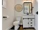 Stylish half-bath with modern fixtures, decorative wall art, and a sleek vanity at 767 Farmstead Rd, Suwanee, GA 30024