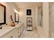 Bathroom with double vanity, large mirrors, and walk-in shower with marble tile at 767 Farmstead Rd, Suwanee, GA 30024