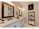 Bathroom featuring a double vanity, modern lighting fixtures, and frameless glass shower at 767 Farmstead Rd, Suwanee, GA 30024