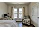 Comfortable bedroom featuring a bed, a chair, a window, and an interior design that inspires comfort at 767 Farmstead Rd, Suwanee, GA 30024